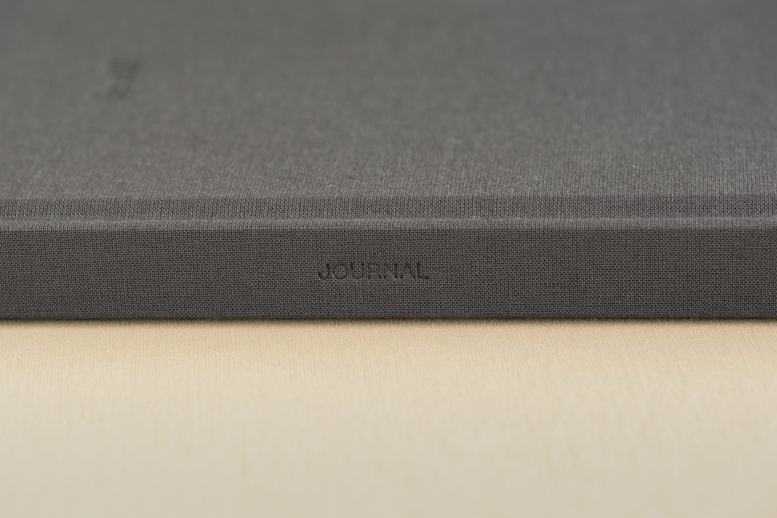 Close detail of JOURNAL debossed into the Slate spine of the be still journal